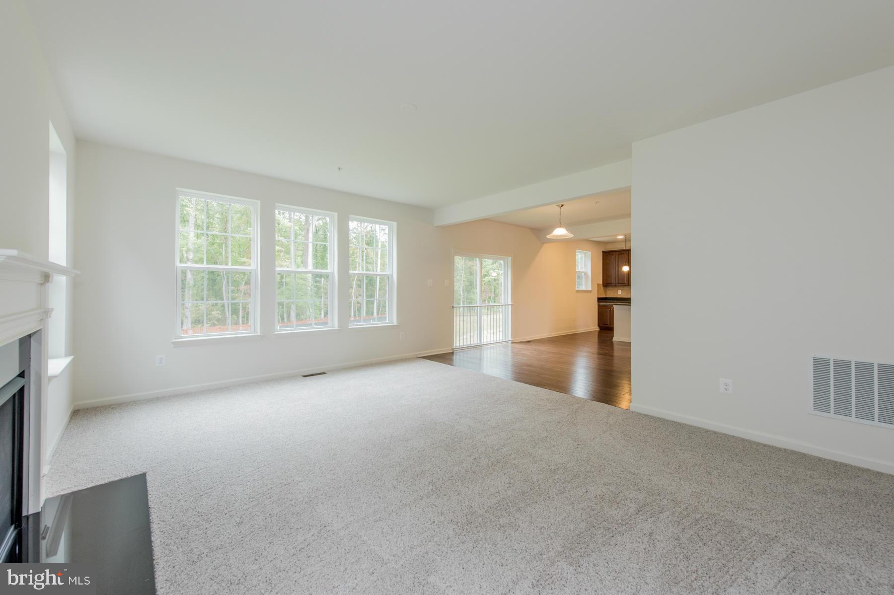 10515 Braddock Run Road Middle River, MD 21220 - Photo 14 of 27 a view of a big room with windows and chandelier fan