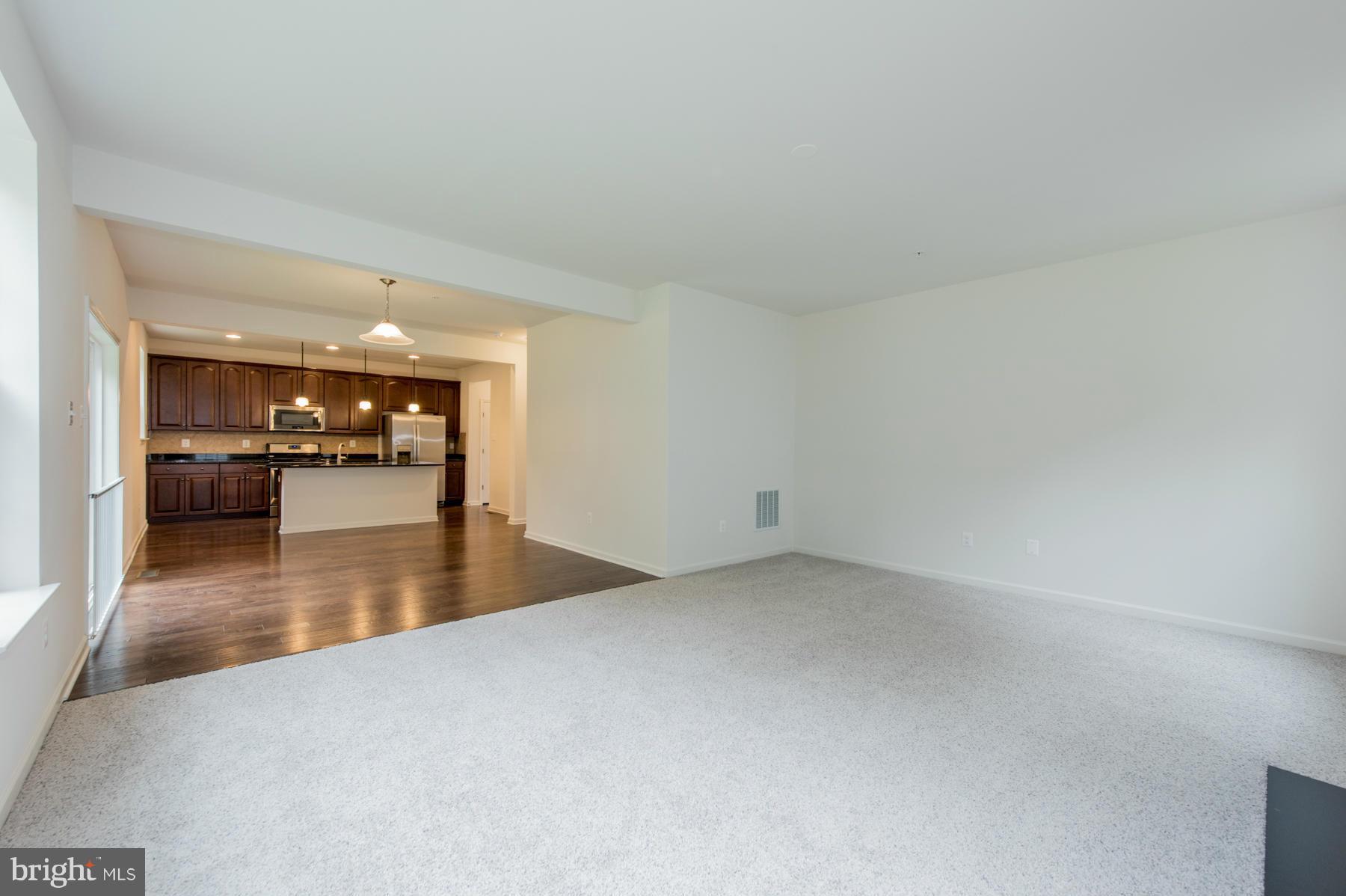 10515 Braddock Run Road Middle River, MD 21220 - Photo 15 of 27 a view of a living room and kitchen with furniture