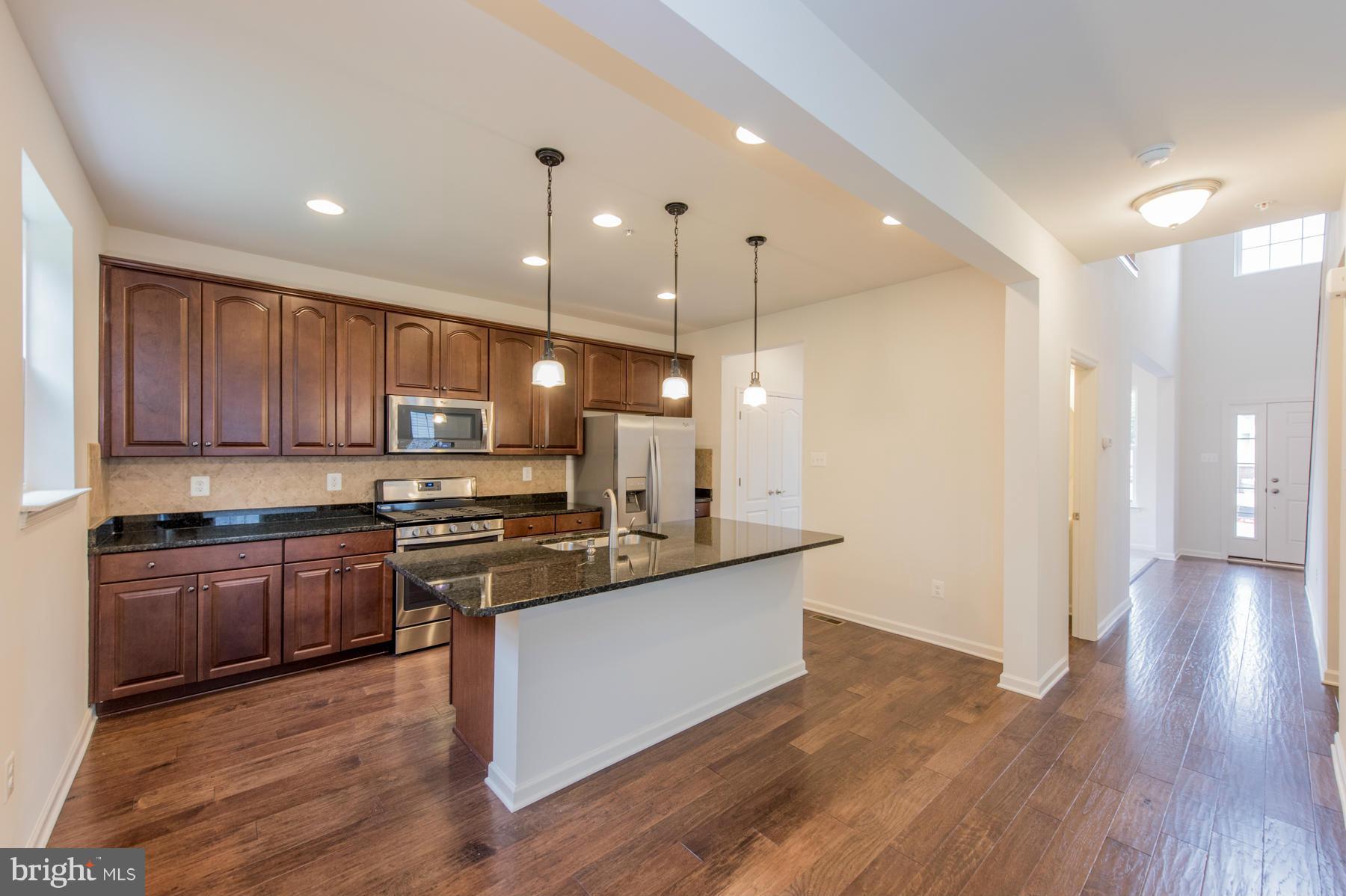 10515 Braddock Run Road Middle River, MD 21220 - Photo 10 of 27 a kitchen with stainless steel appliances granite countertop wooden floors and view