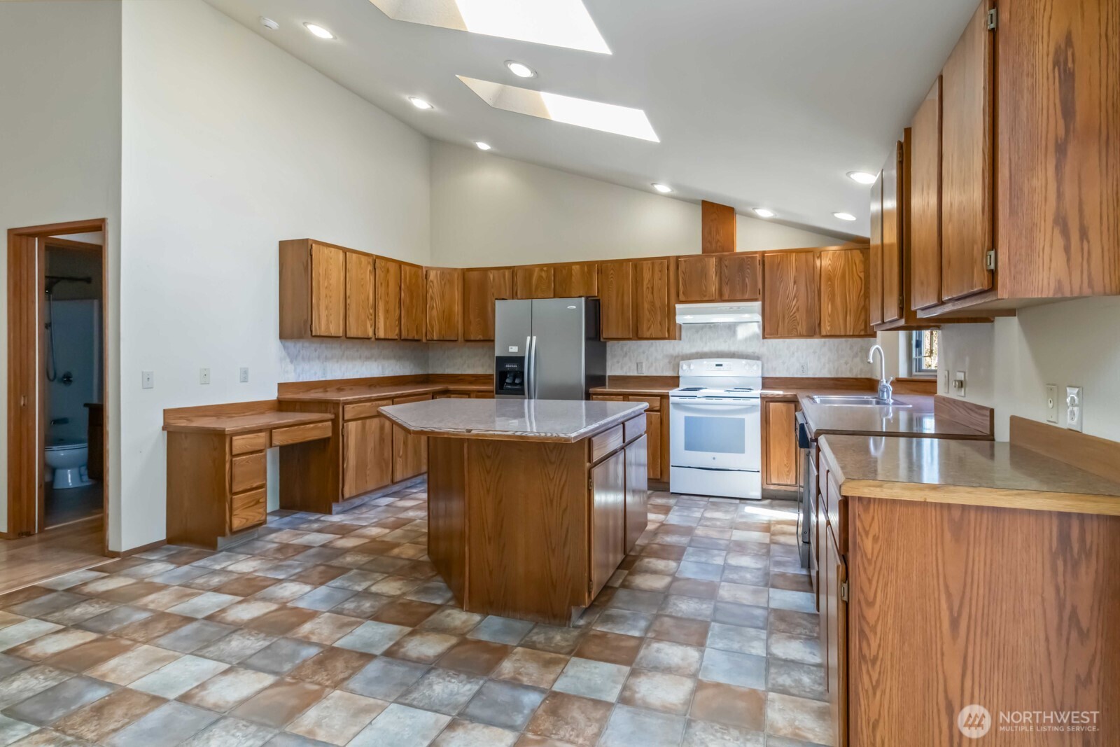 207 Tillicum Drive Chehalis, WA 98532 - Photo 24 of 40 a kitchen with stainless steel appliances granite countertop a stove top oven a sink a counter top space and cabinets