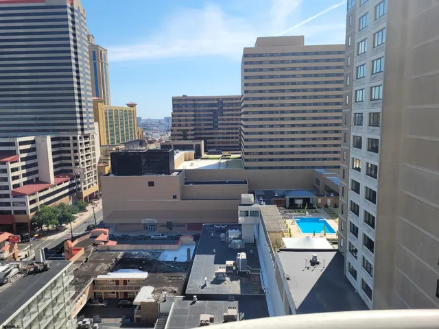a kitchen with a refrigerator a stove and wooden floor