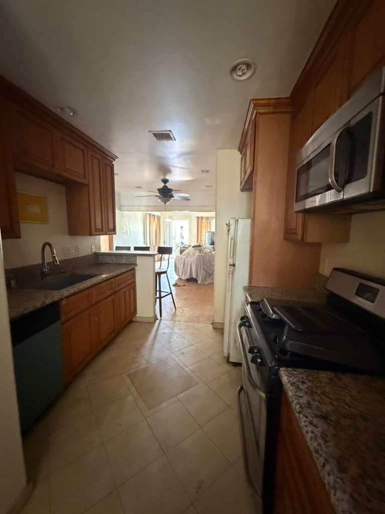 309 Alhambra Road Alhambra, CA 91801 - Photo 5 of 10 a kitchen with a stove a sink and a microwave