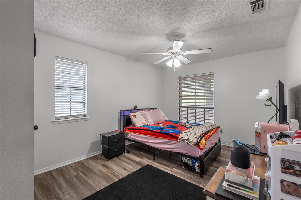 215 Lajuana Drive Waco, TX 76705 - Photo 20 of 33 Bedroom with wood finished floors, ceiling fan, and a textured ceiling