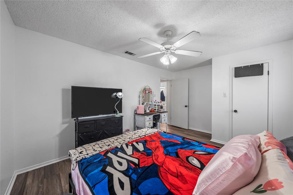 215 Lajuana Drive Waco, TX 76705 - Photo 21 of 33 Bedroom with wood finished floors, a textured ceiling, ceiling fan, and a closet