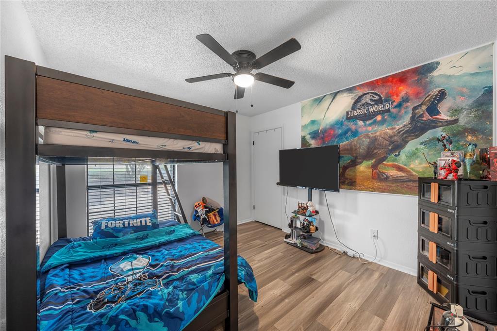 215 Lajuana Drive Waco, TX 76705 - Photo 22 of 33 Bedroom with wood finished floors, a textured ceiling, and ceiling fan
