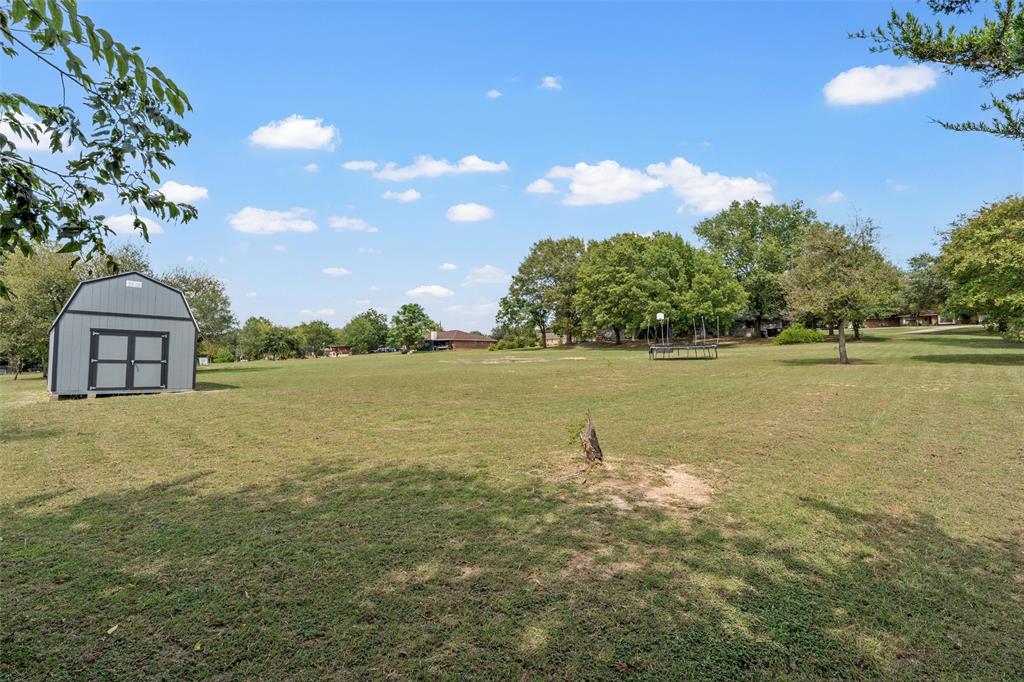215 Lajuana Drive Waco, TX 76705 - Photo 26 of 33 View of grassy yard with a storage unit