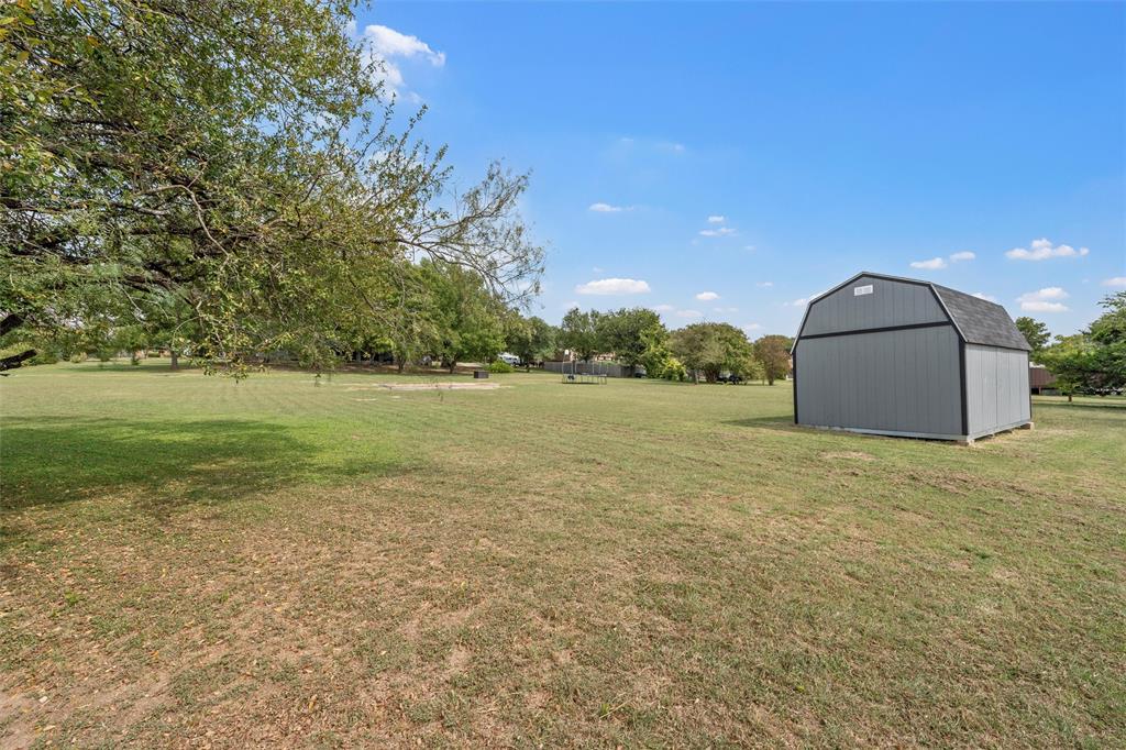 215 Lajuana Drive Waco, TX 76705 - Photo 27 of 33 View of grassy yard with an outdoor structure