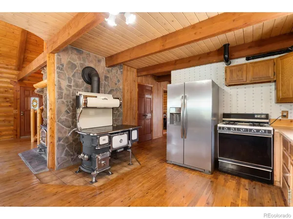 a dining room with stainless steel appliances kitchen island granite countertop a table and chairs