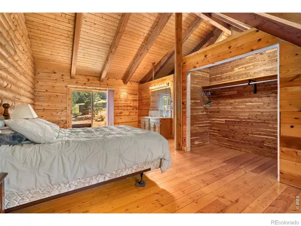 a living room with a bed furniture and a flat screen tv