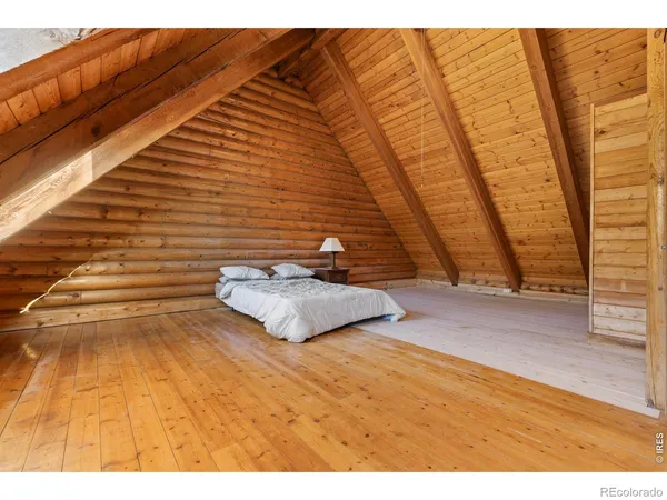 a bedroom with a bed and a chair