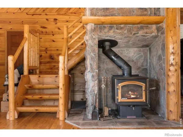 a kitchen with stainless steel appliances wooden floors and white cabinets