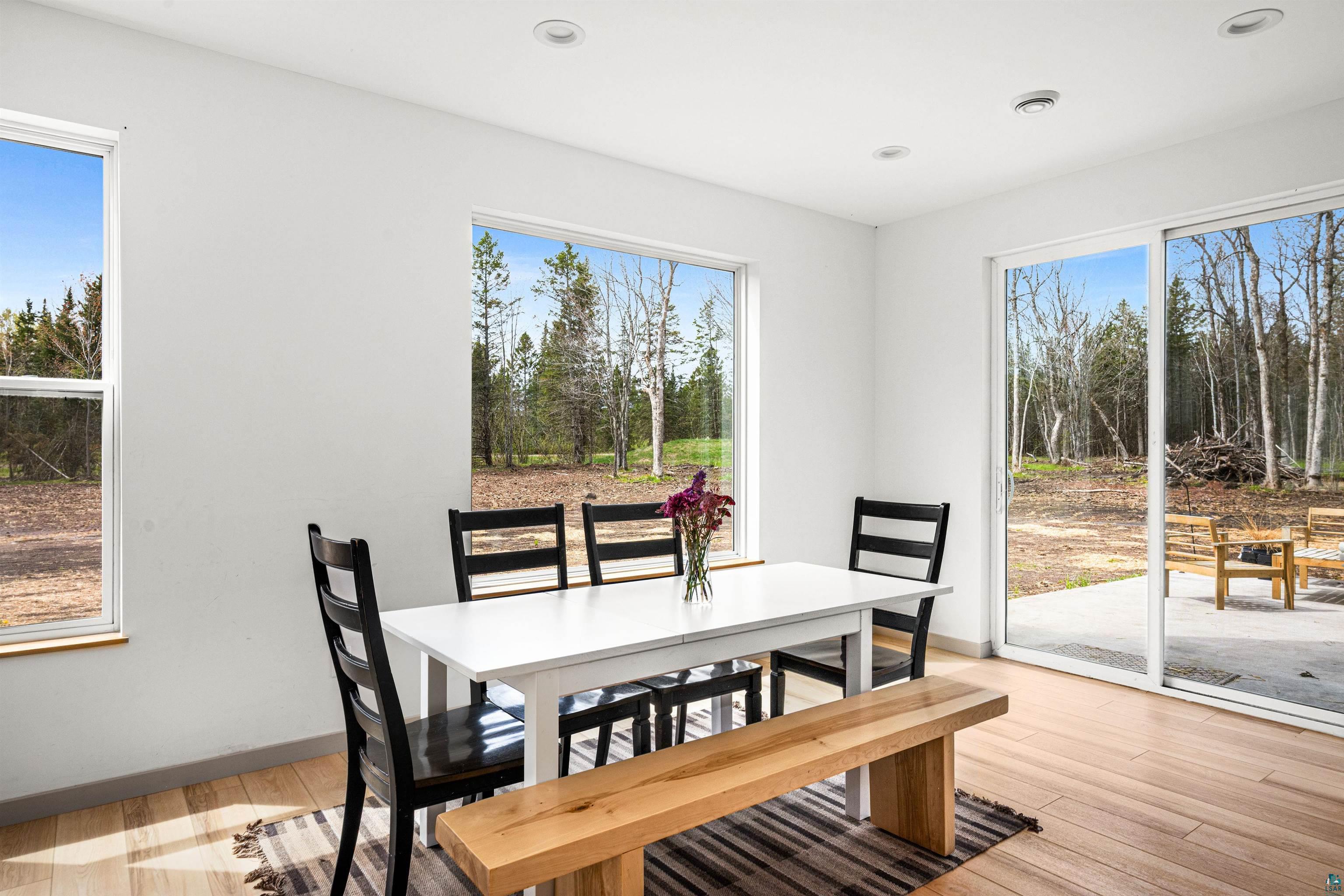 1825 East Shilhon Road Duluth, MN 55804 - Photo 16 of 37 Bright dining area featuring a wealth of windows w/views & access to a large concrete patio for outdoor dining & relaxation.