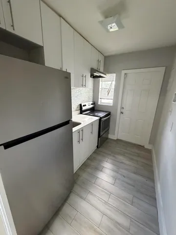 a kitchen with stainless steel appliances a refrigerator sink and microwave