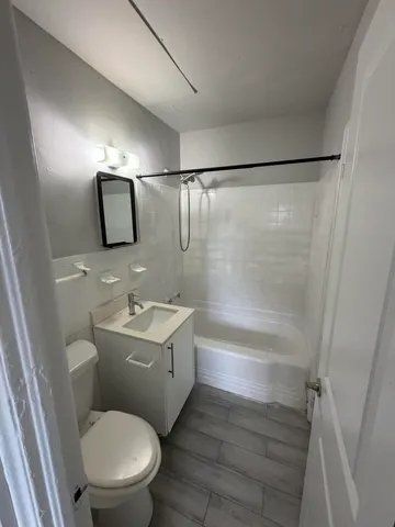 a bathroom with a toilet a sink and bathtub