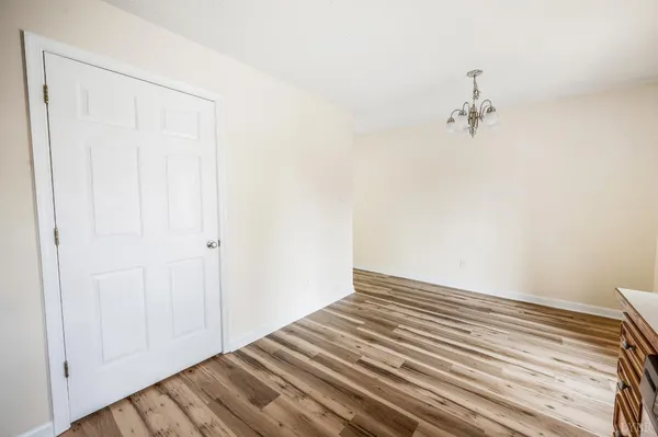 a view of a room with wooden floor and ceiling fan