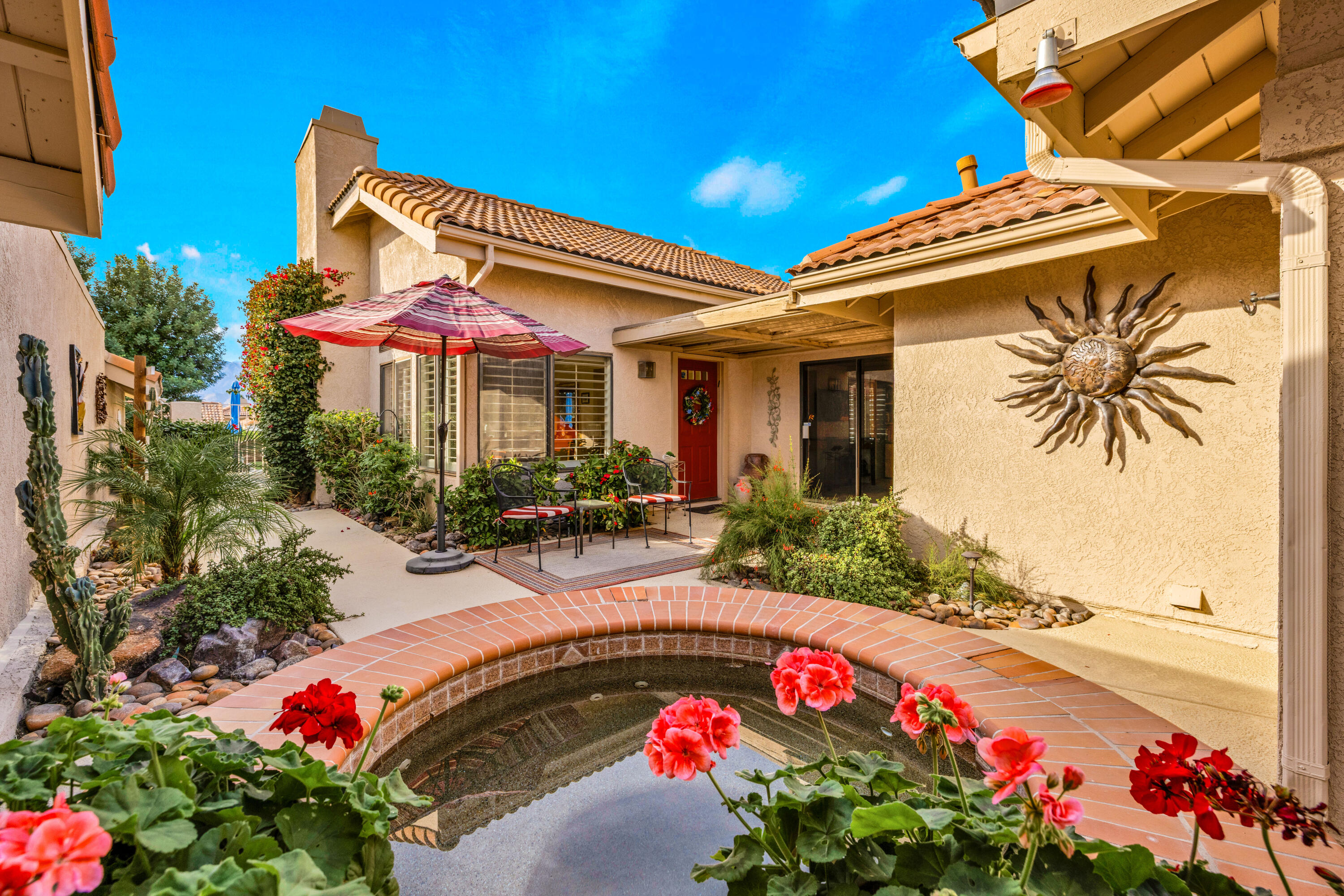 45 Verde Way Palm Desert, CA 92260 - Photo 1 of 48 a view of swimming pool with a table and chairs under an umbrella