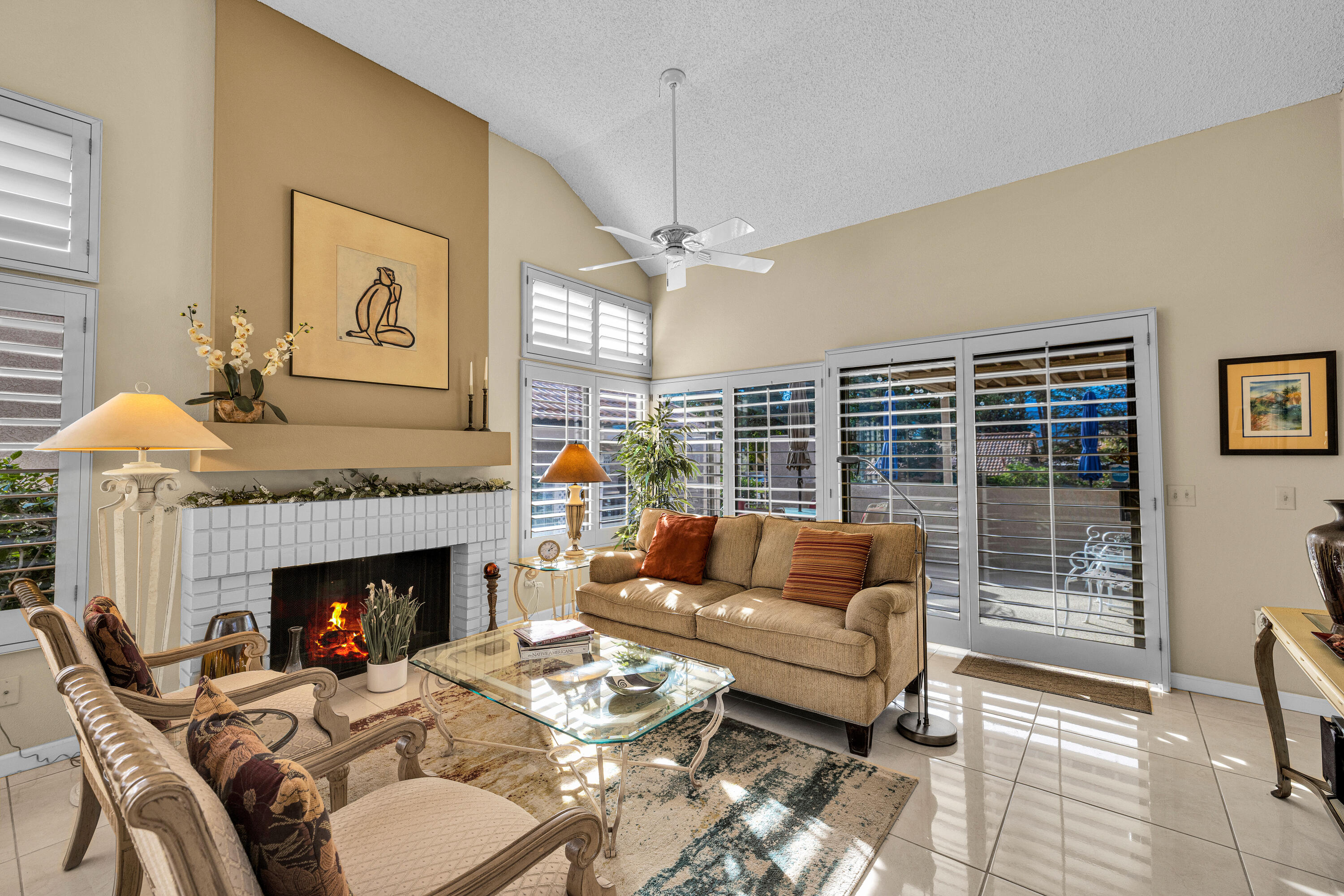 45 Verde Way Palm Desert, CA 92260 - Photo 15 of 48 a living room with furniture and a fireplace