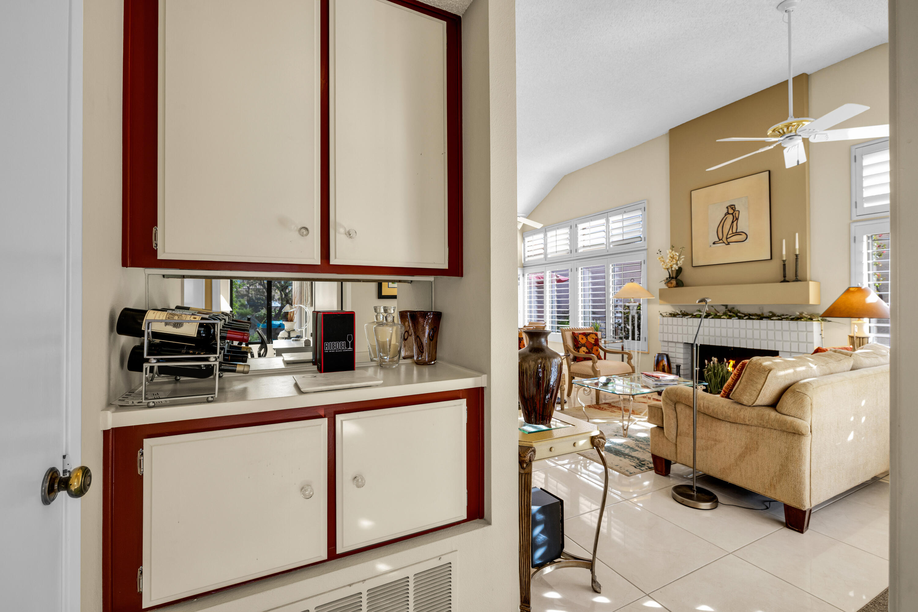 45 Verde Way Palm Desert, CA 92260 - Photo 18 of 48 a living room with furniture a fireplace and a large mirror