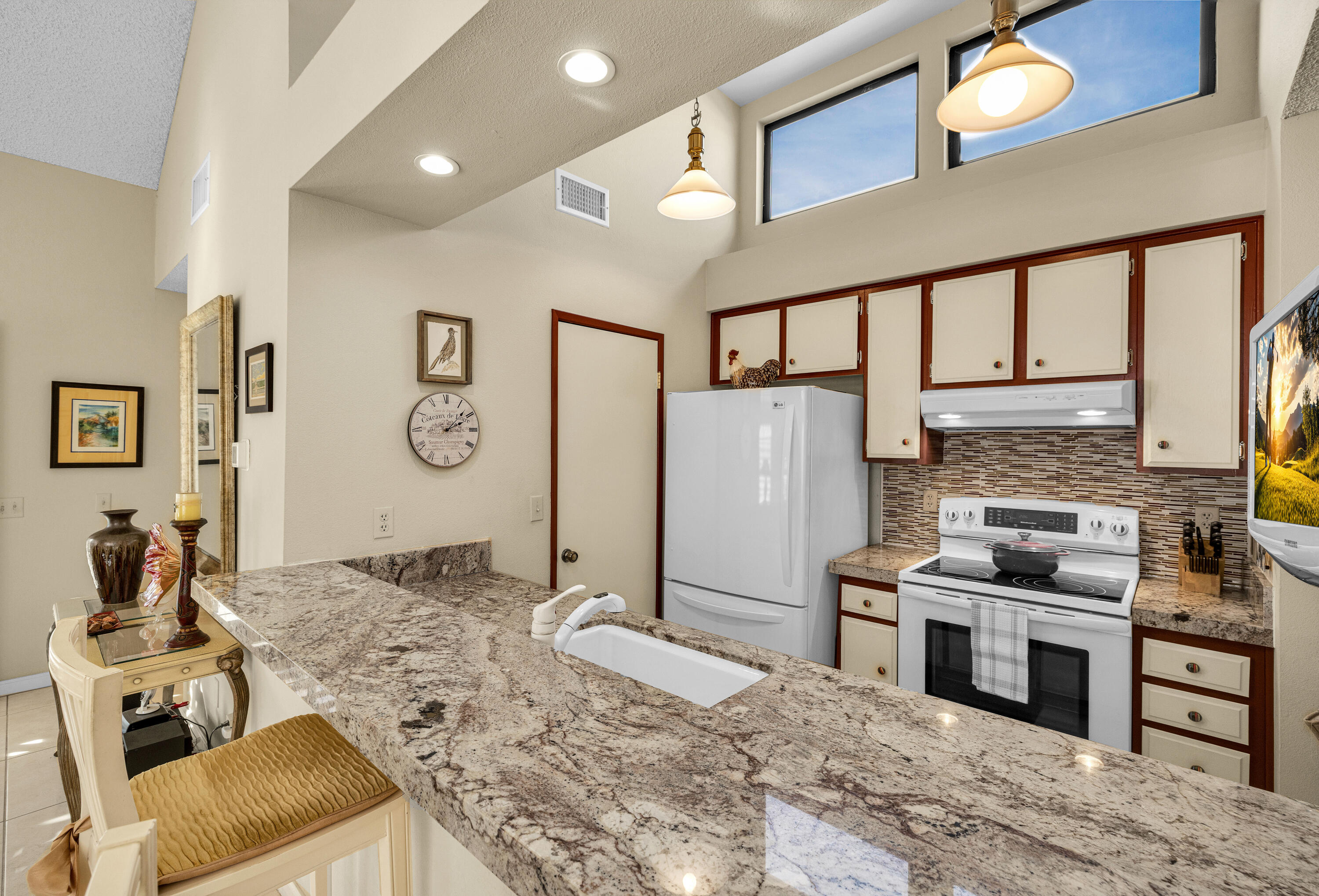 45 Verde Way Palm Desert, CA 92260 - Photo 20 of 48 a kitchen with stainless steel appliances kitchen island granite countertop a refrigerator oven stove a sink and dishwasher