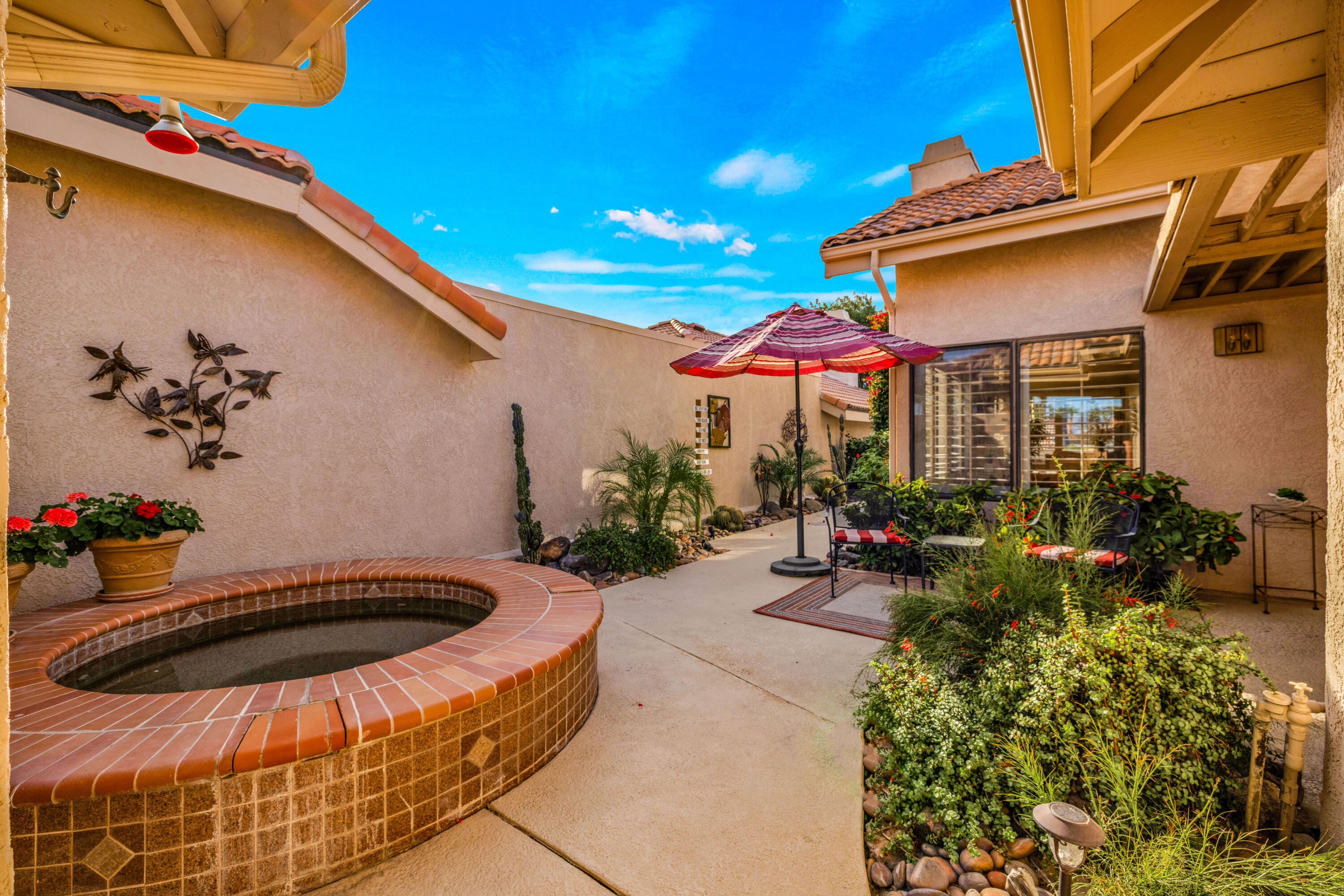 45 Verde Way Palm Desert, CA 92260 - Photo 2 of 48 a view of a patio with a table and chairs and potted plants
