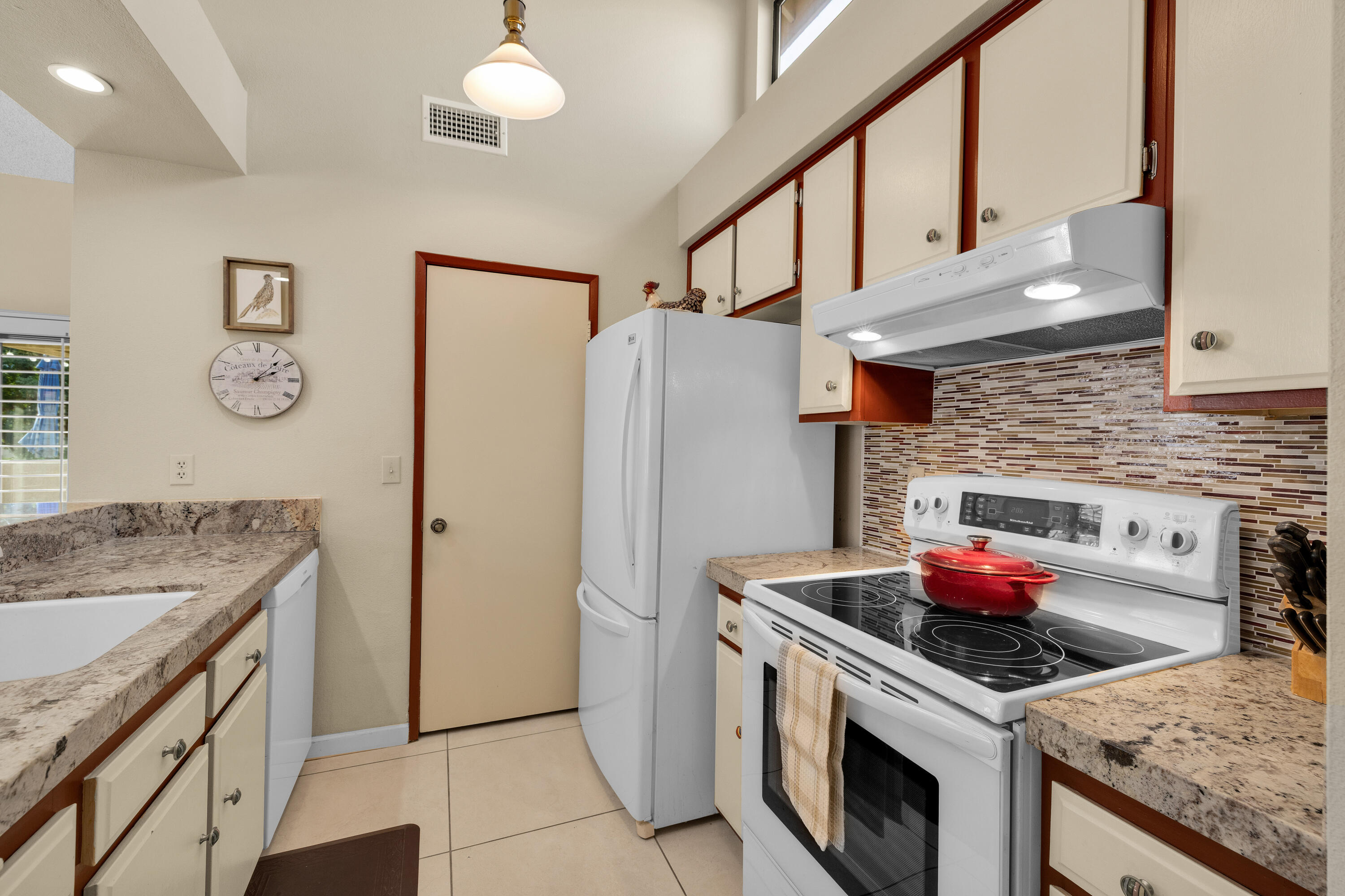 45 Verde Way Palm Desert, CA 92260 - Photo 21 of 48 a kitchen with stainless steel appliances granite countertop a stove and a refrigerator