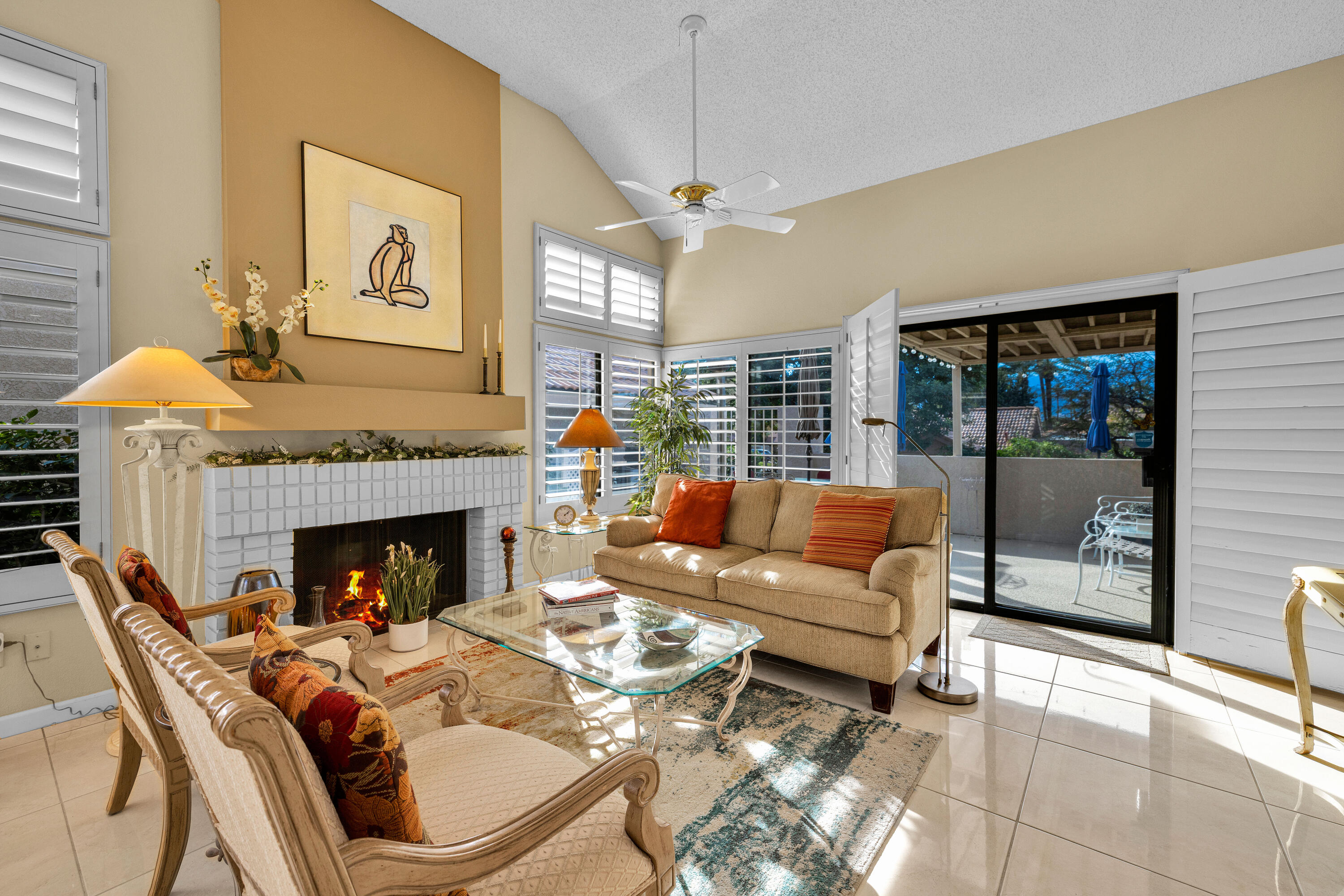 45 Verde Way Palm Desert, CA 92260 - Photo 24 of 48 a living room with furniture and a fireplace