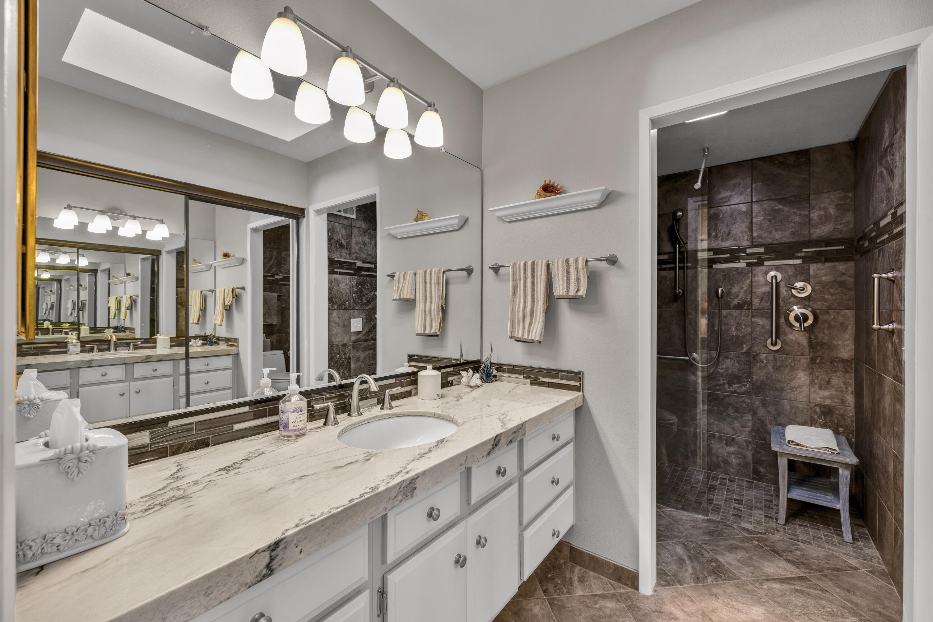 45 Verde Way Palm Desert, CA 92260 - Photo 28 of 48 a bathroom with a double vanity sink mirror and shower