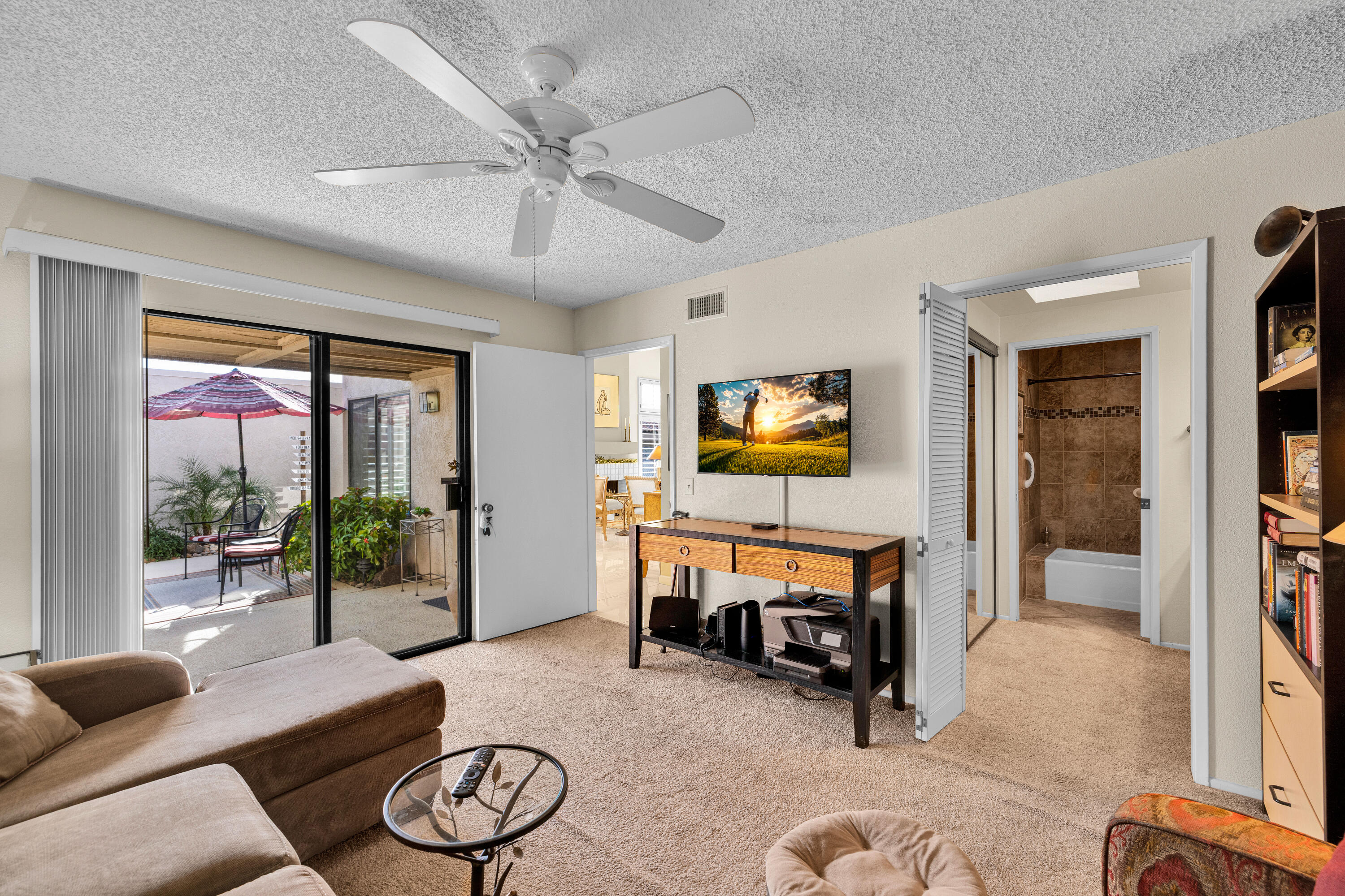 45 Verde Way Palm Desert, CA 92260 - Photo 32 of 48 a living room with furniture and a flat screen tv with wooden floor