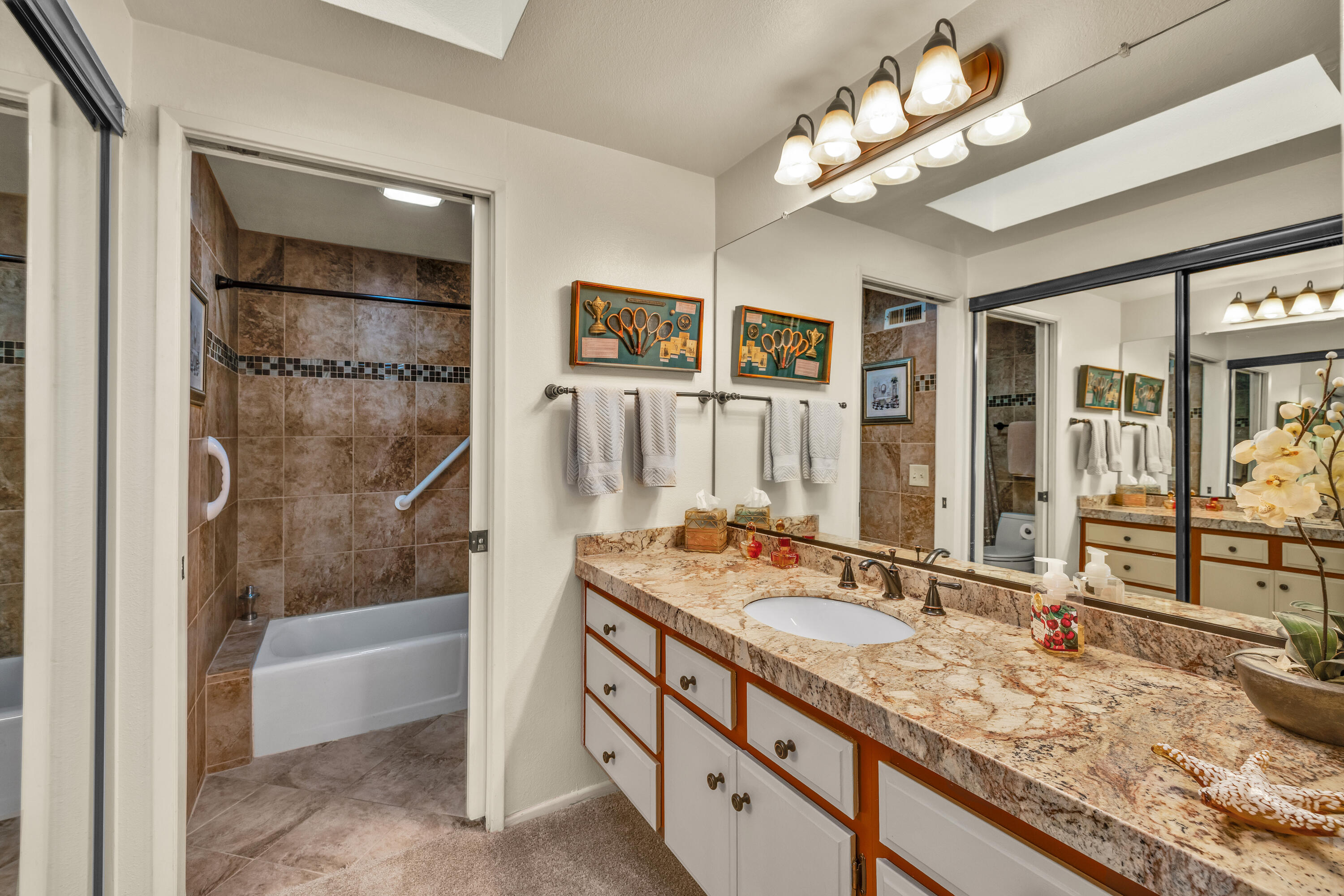 45 Verde Way Palm Desert, CA 92260 - Photo 33 of 48 a bathroom with a granite countertop double vanity sink a mirror a shower and a bathtub