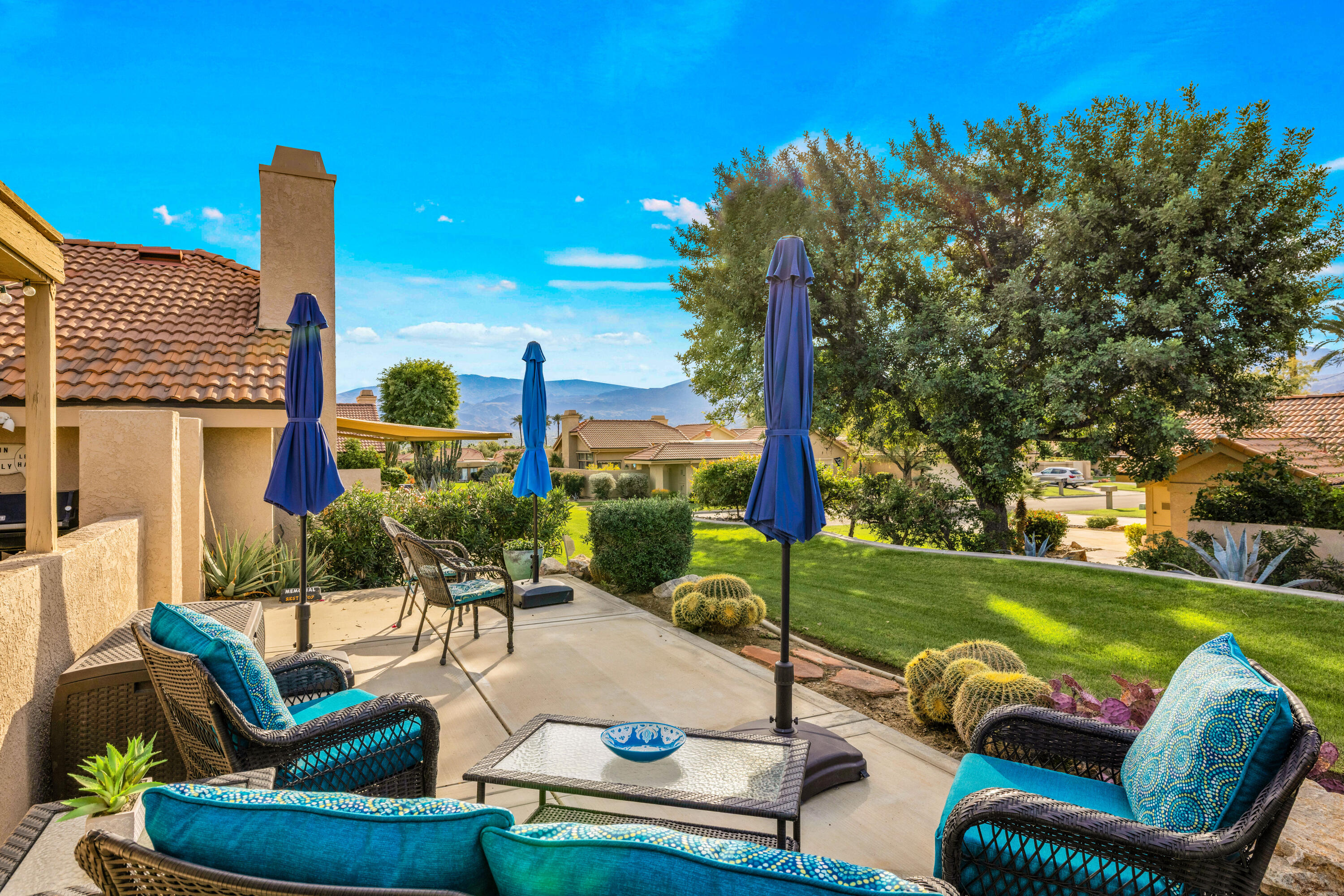 45 Verde Way Palm Desert, CA 92260 - Photo 8 of 48 a view of a patio with couches chairs potted plants and a yard