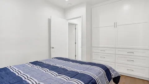 a bedroom with a bed and cabinets