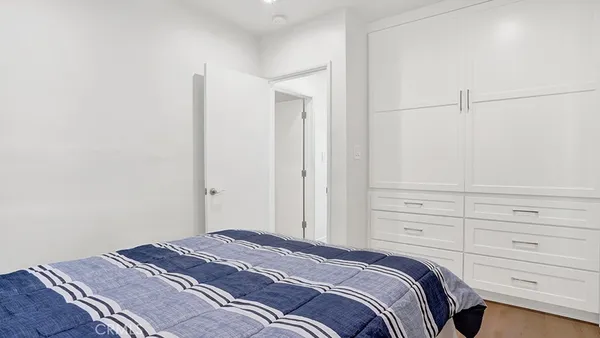 a bedroom with a bed and cabinets