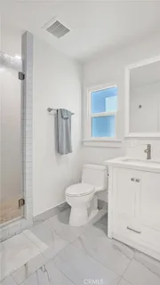 a bathroom with a toilet sink and a mirror