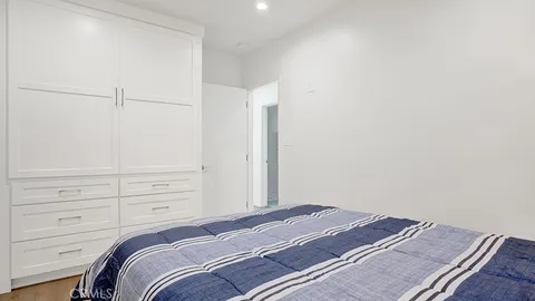 a bedroom with a bed and cabinet