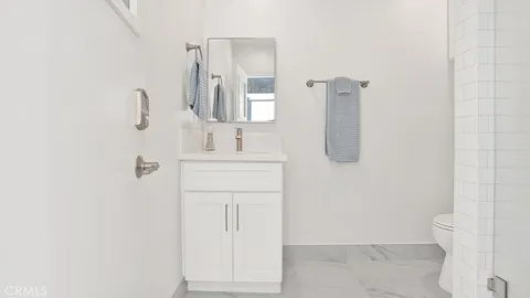 a bathroom with a bathtub sink and mirror