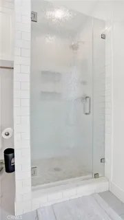 a bathroom with a glass shower door