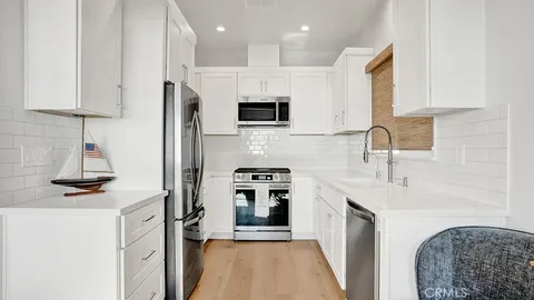 a kitchen with a sink stainless steel appliances and cabinets