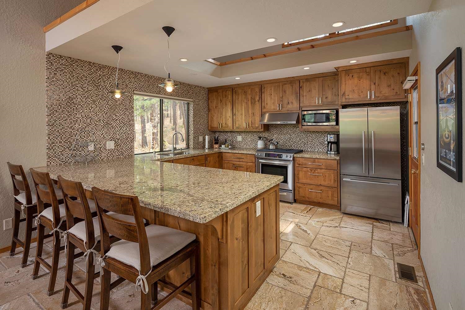 342 Skidder Trail Truckee, CA 96161 - Photo 6 of 21 a kitchen with stainless steel appliances granite countertop a table chairs sink and refrigerator