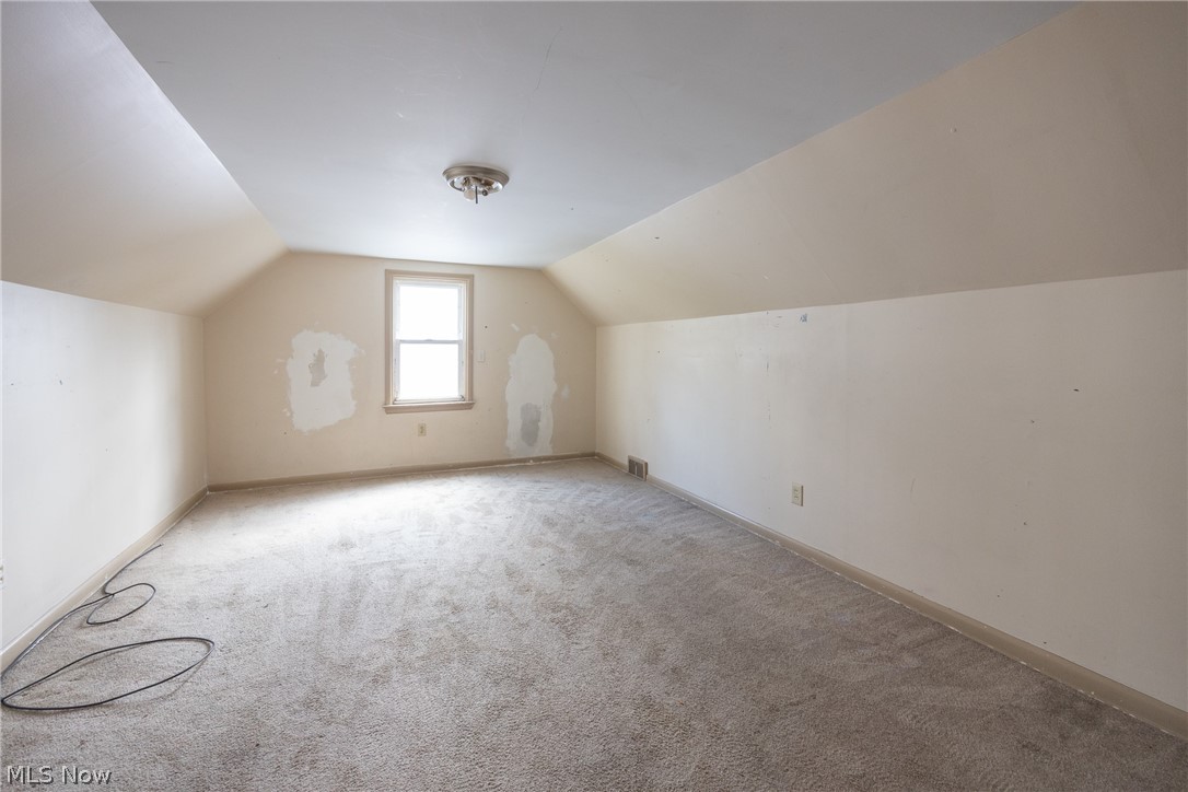 4344 West Anderson Road South Euclid, OH 44121 - Photo 12 of 14 Additional living space with vaulted ceiling and light carpet