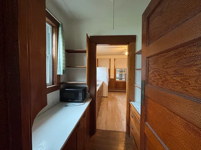 a hallway with a large mirror and a wooden floor