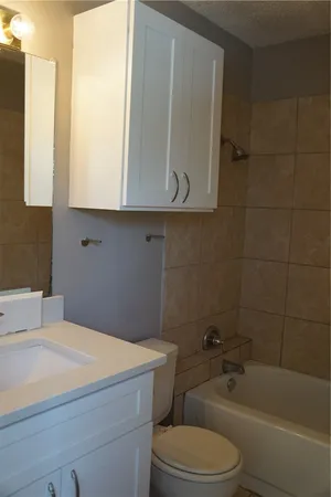 a bathroom with a toilet a sink and bathtub