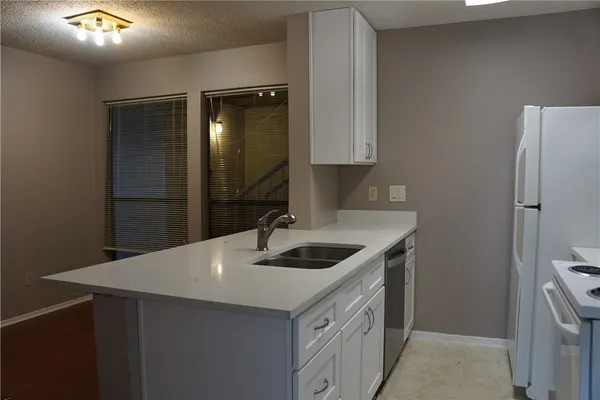a kitchen with a sink and a refrigerator