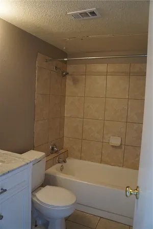 a bathroom with a toilet and bathtub