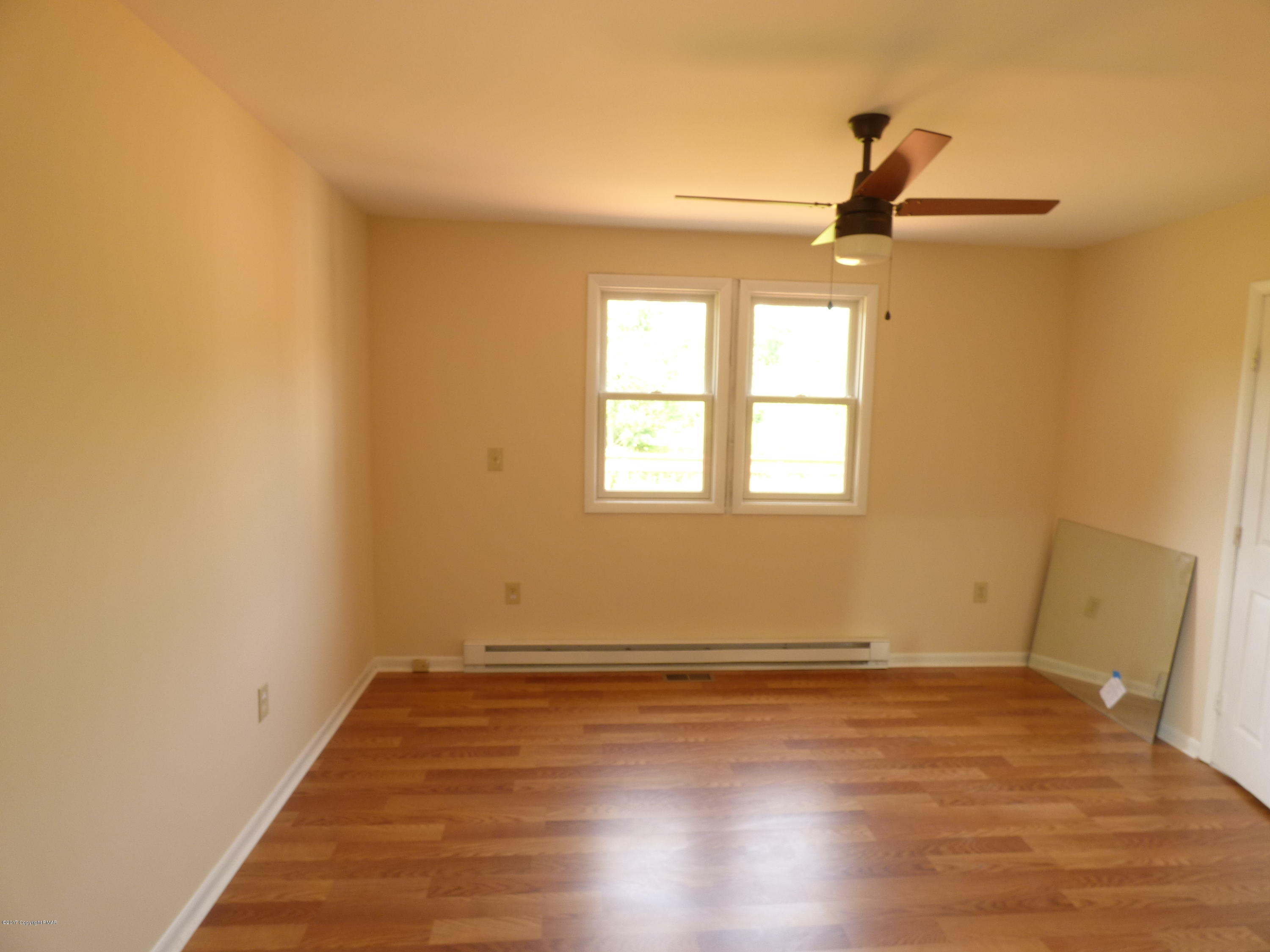 1178 Mattioli Road Bartonsville, PA 18321 - Photo 13 of 21 an empty room with wooden floor fan and windows