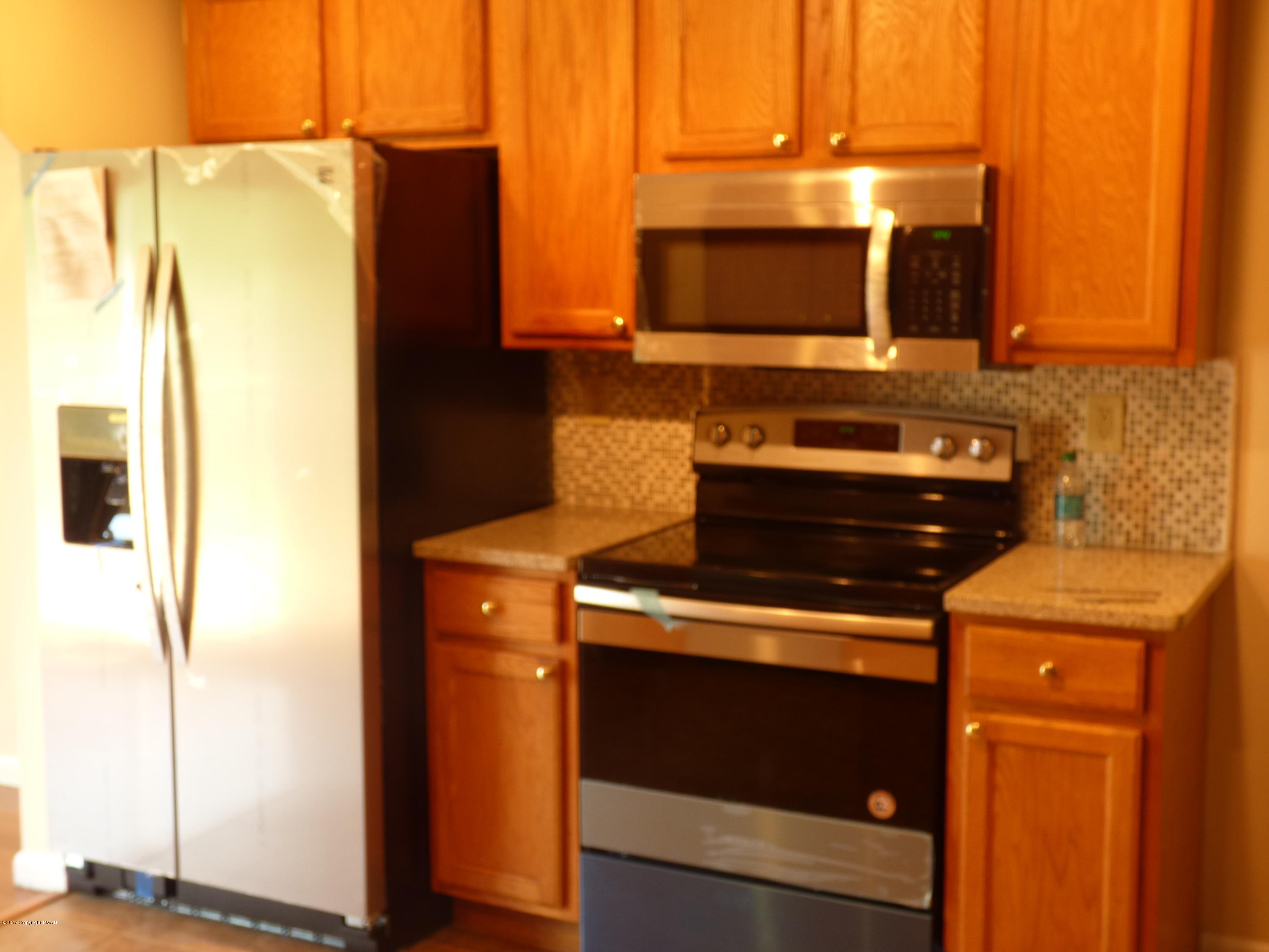 1178 Mattioli Road Bartonsville, PA 18321 - Photo 4 of 21 a kitchen with a stove and a microwave