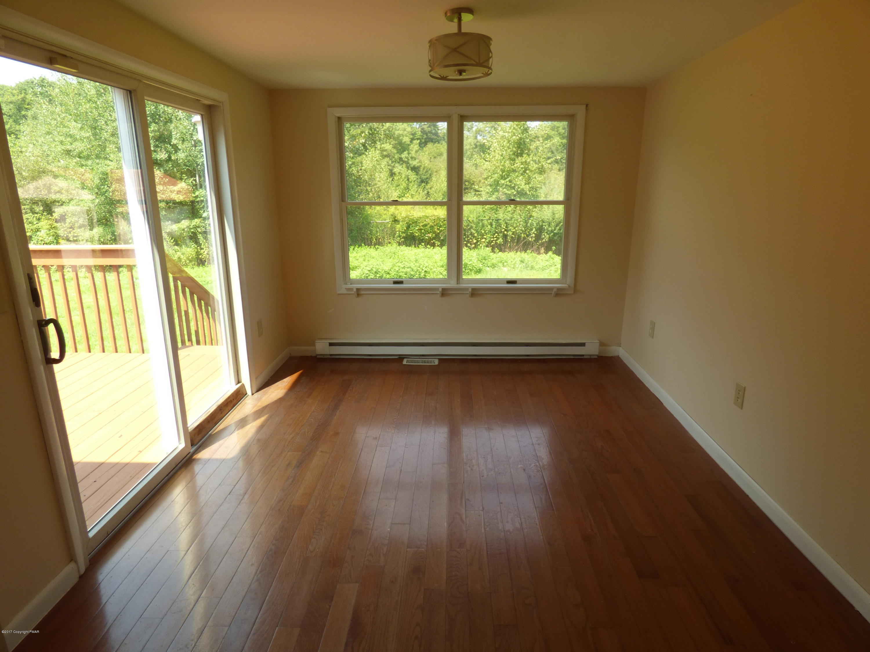 1178 Mattioli Road Bartonsville, PA 18321 - Photo 6 of 21 an empty room with wooden floor and windows