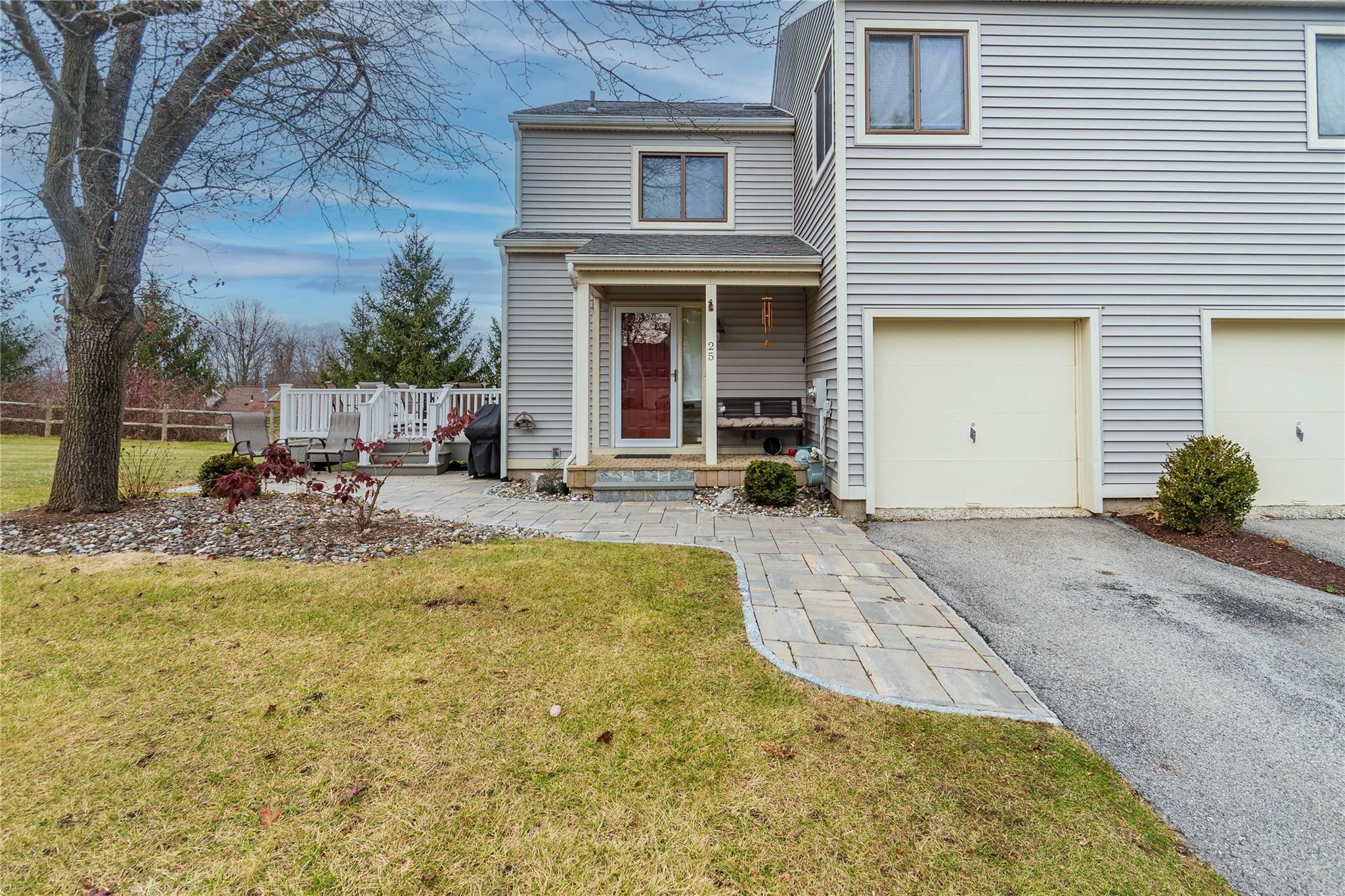 View of front of property with a front lawn and a garage