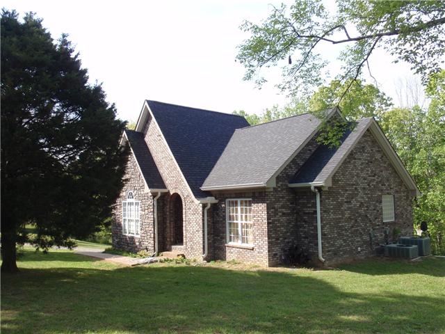 9151 Buck Litton Road Lyles, TN 37098 - Photo 4 of 20 a front view of house with a garden and trees