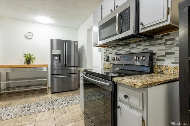 a kitchen with a stove microwave and refrigerator