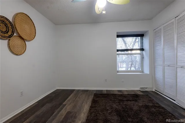a view of a room with wooden floor and window
